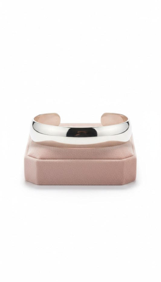 Polished sterling silver open cuff bracelet with a sleek architectural design and reflective finish