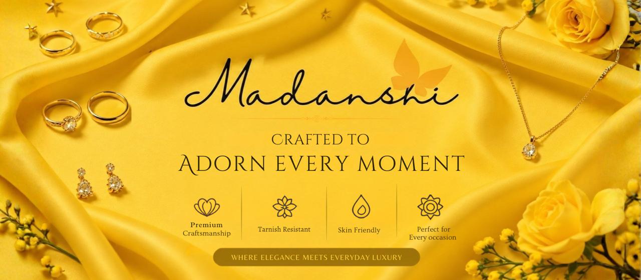 A yellow satin fabric backdrop with gold jewelry pieces including rings, earrings, and a necklace, decorated with yellow roses. The text 'Madanshi' is written in elegant black script, with the tagline 'CRAFTED TO ADORN EVERY MOMENT' and four feature icons below.
